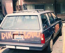 My big blue station wagon with orange spray paint on it. It's vandalized with words like Lesbo, homo and a misspelled dike with an i, not a y.